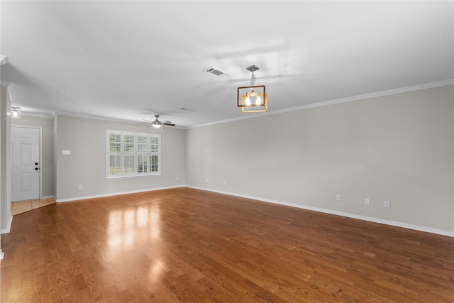 empty room with hardwood / wood-style flooring, ornamental molding, and ceiling fan