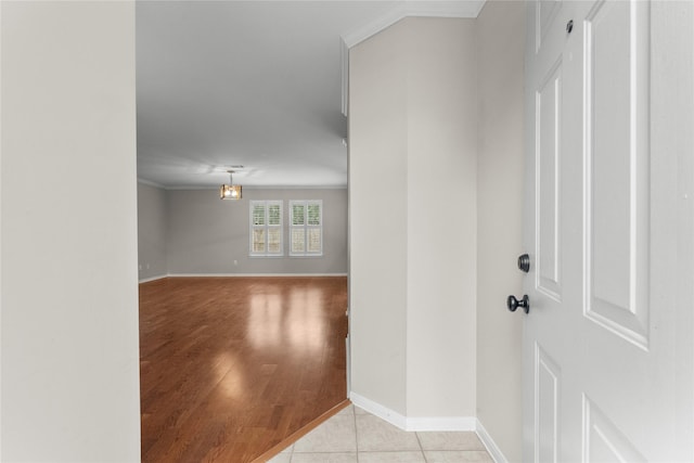 entrance foyer with ornamental molding and light tile patterned floors