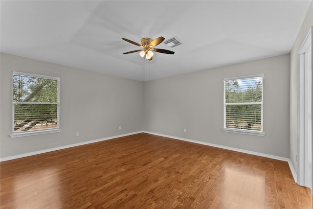 spare room with hardwood / wood-style flooring and ceiling fan