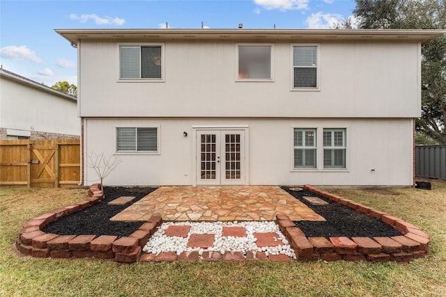 back of house featuring a yard, a patio area, and french doors