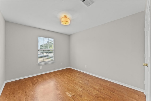 spare room featuring hardwood / wood-style floors