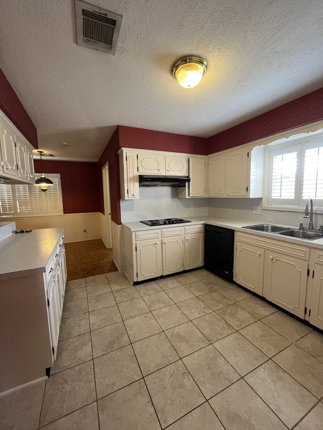 kitchen featuring white cabinetry, sink, light tile patterned floors, black appliances, and a textured ceiling