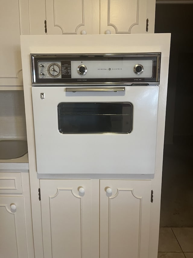 interior details featuring oven and white cabinets