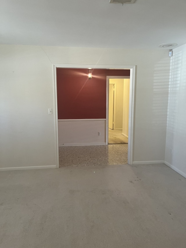 unfurnished room with light colored carpet