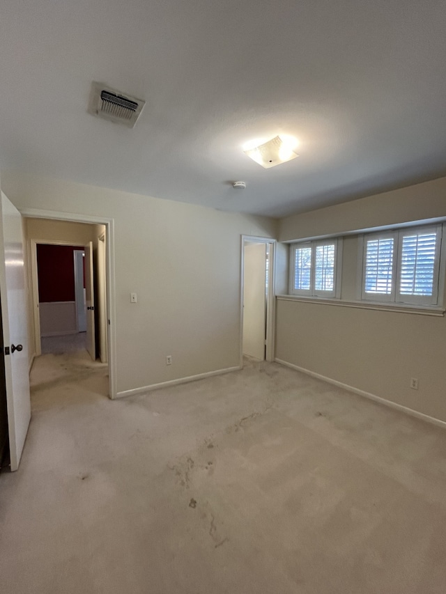 empty room with light colored carpet