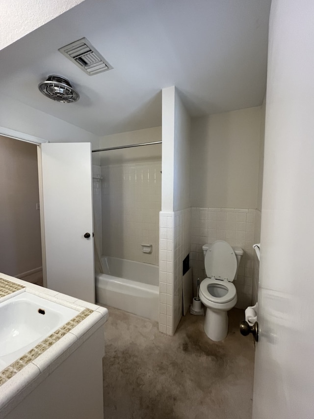 full bathroom featuring vanity, tile walls, shower / bathtub combination, and toilet