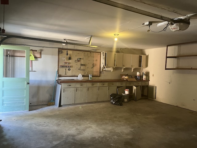 garage with a garage door opener and a workshop area