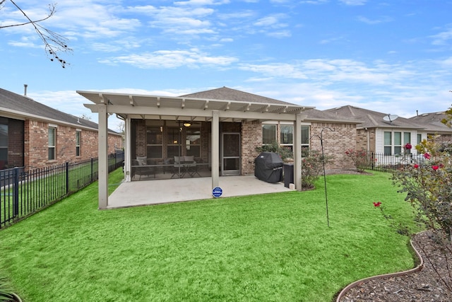 rear view of house featuring brick siding, a lawn, a patio area, and a fenced backyard