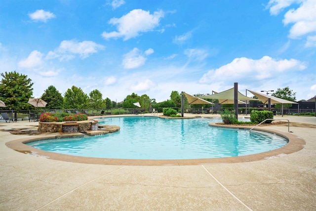 pool featuring fence and a patio