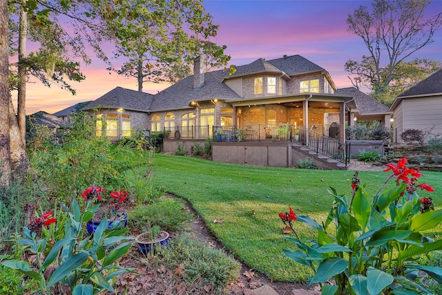 yard at dusk with a hot tub