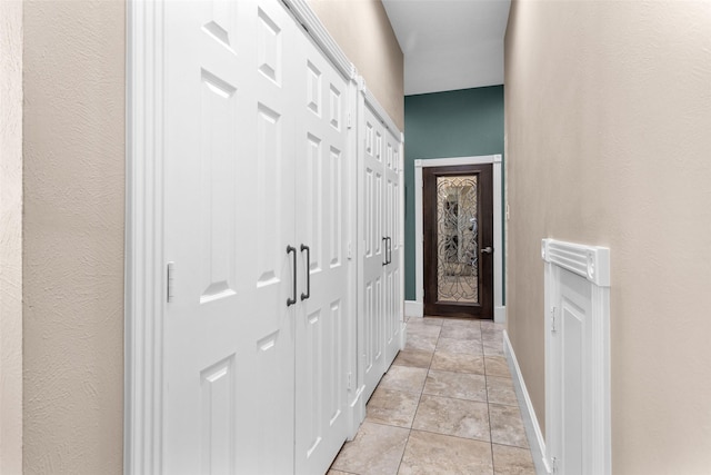 hallway with light tile patterned floors