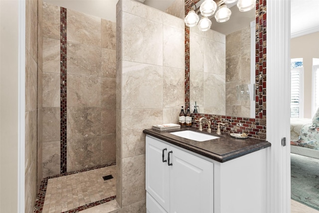 bathroom featuring vanity, tile walls, and tiled shower