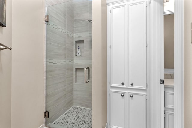 bathroom with a shower with door