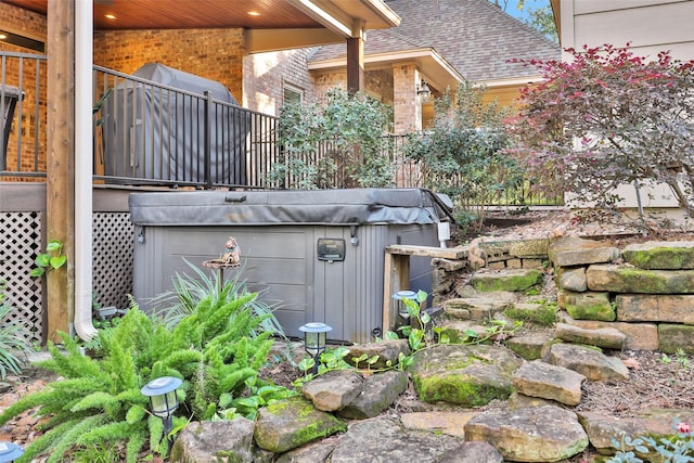 exterior space with a hot tub