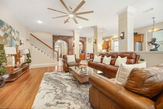 living room featuring light hardwood / wood-style flooring and ornate columns