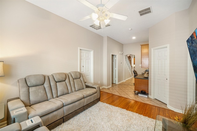 living room with ceiling fan and light hardwood / wood-style floors