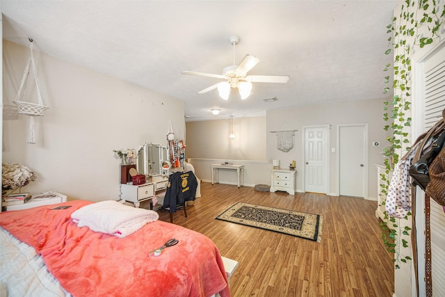 bedroom featuring hardwood / wood-style floors and ceiling fan