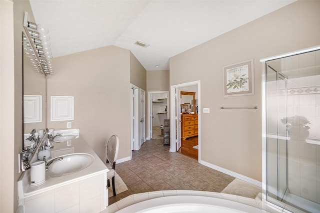 bathroom featuring shower with separate bathtub, lofted ceiling, vanity, and tile patterned floors