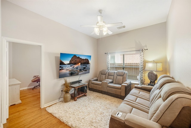 living room featuring ceiling fan and light wood-type flooring