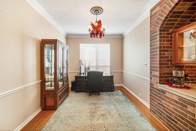 home office with hardwood / wood-style flooring, crown molding, and a textured ceiling