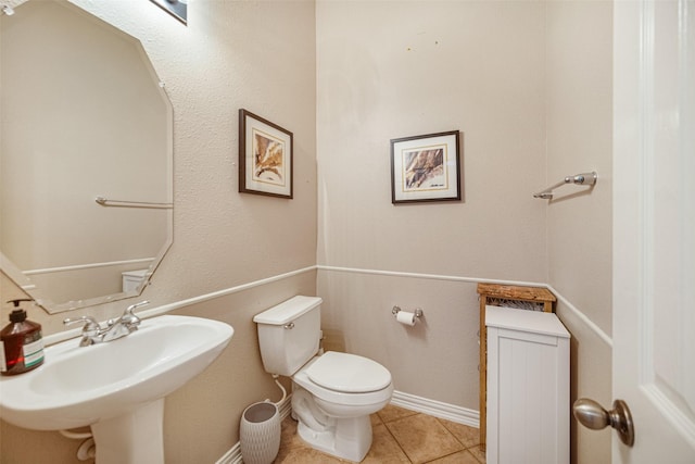 bathroom featuring tile patterned flooring, sink, and toilet