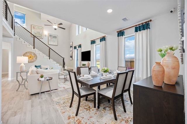 dining space featuring visible vents, stairs, recessed lighting, light wood-style floors, and a ceiling fan