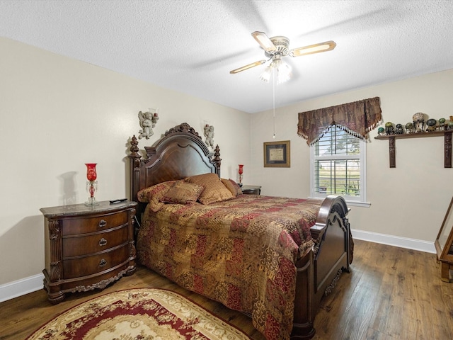 bedroom featuring ceiling fan, dark hardwood / wood-style floors, and a textured ceiling