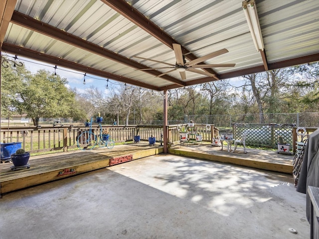 view of patio featuring ceiling fan, a deck, and a playground