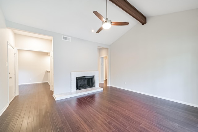 unfurnished living room with dark wood-type flooring, ceiling fan, a fireplace, and lofted ceiling with beams