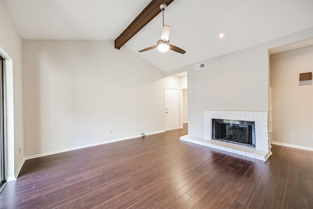 unfurnished living room featuring a brick fireplace, dark wood-type flooring, vaulted ceiling with beams, and ceiling fan