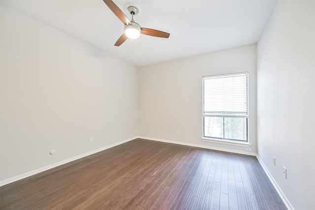 unfurnished room featuring dark wood-type flooring and ceiling fan