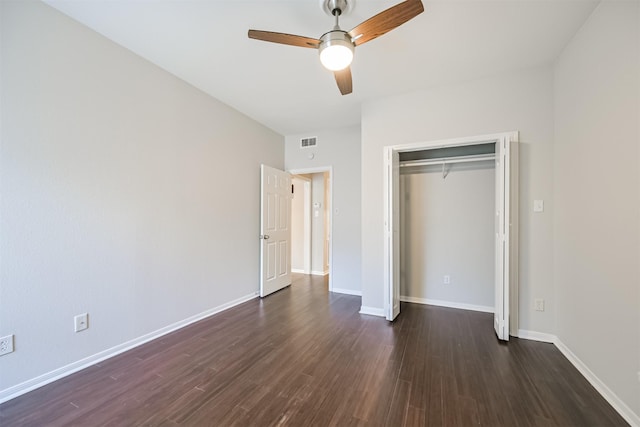 unfurnished bedroom featuring dark wood-type flooring, a closet, and ceiling fan