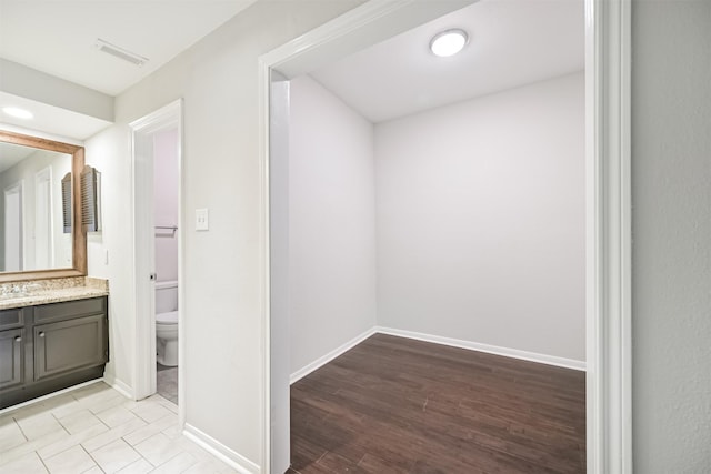 bathroom featuring vanity, toilet, and wood-type flooring