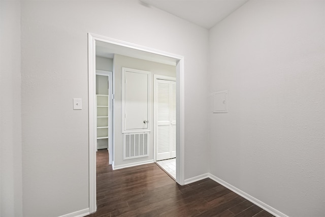 hallway with dark hardwood / wood-style flooring