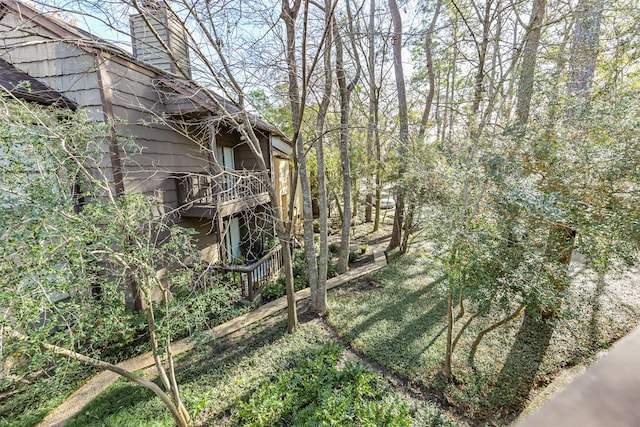 view of side of property with a balcony