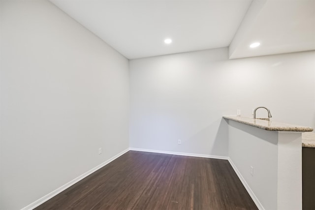 bar with sink and dark hardwood / wood-style flooring