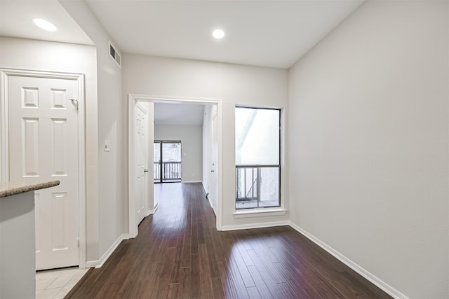 hallway with hardwood / wood-style flooring