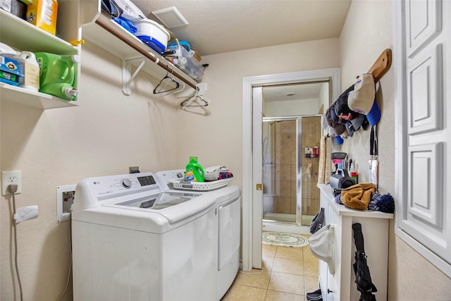 washroom featuring separate washer and dryer and light tile patterned flooring