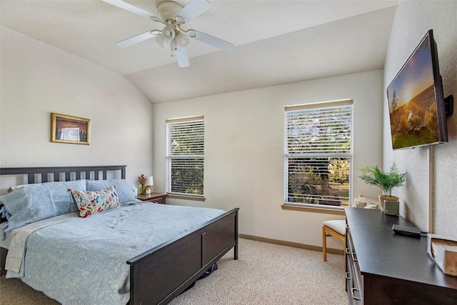 carpeted bedroom featuring ceiling fan, vaulted ceiling, and multiple windows