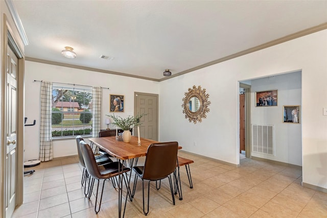 tiled dining room with ornamental molding