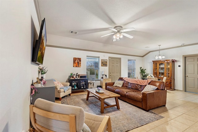 tiled living room with vaulted ceiling, ceiling fan with notable chandelier, and a textured ceiling