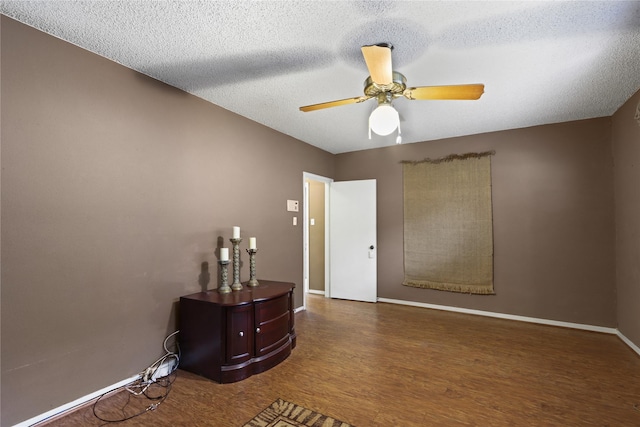 interior space with hardwood / wood-style floors, a textured ceiling, and ceiling fan