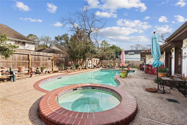 view of pool featuring a patio area and an in ground hot tub