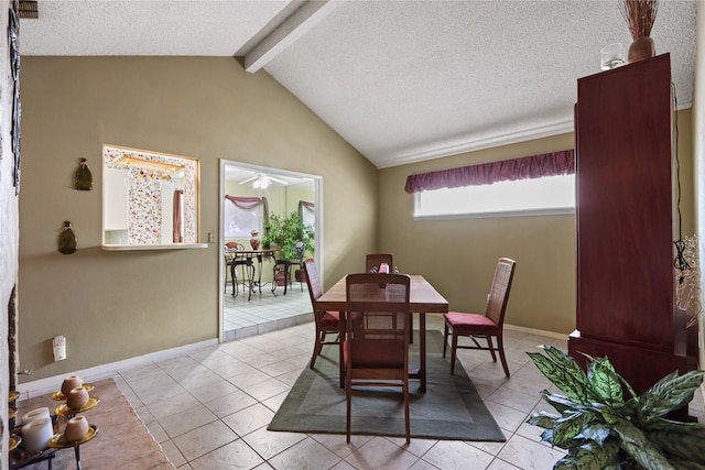 dining area with lofted ceiling with beams, a textured ceiling, and light tile patterned floors