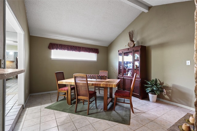 tiled dining area with vaulted ceiling with beams and a textured ceiling