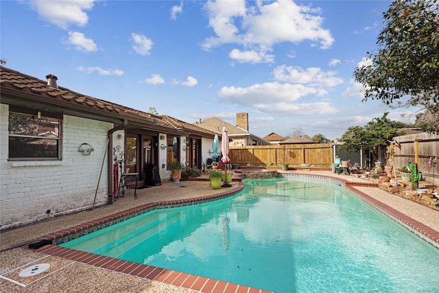 view of swimming pool featuring a patio area