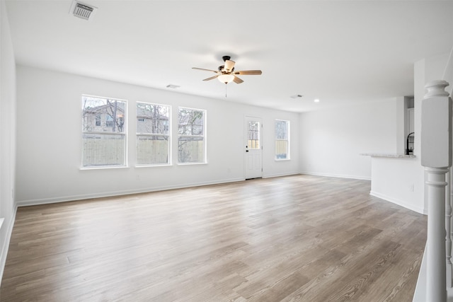 unfurnished living room featuring ceiling fan and light wood-type flooring