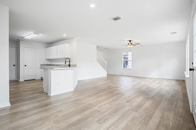 kitchen with ceiling fan and light hardwood / wood-style flooring