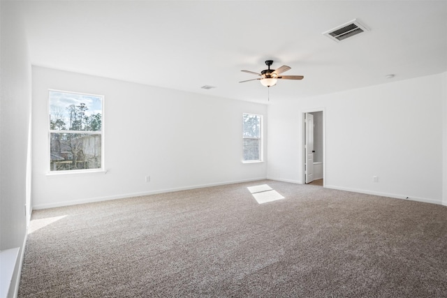 carpeted spare room with ceiling fan