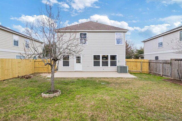 back of property with cooling unit, a yard, and a patio area